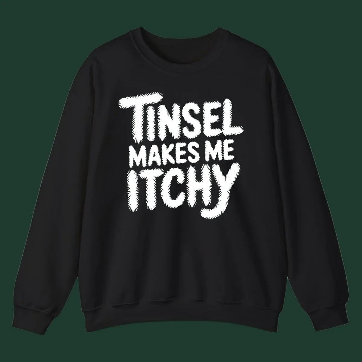 Text design reading "Tinsel Makes Me Itchy" in a fuzzy font.