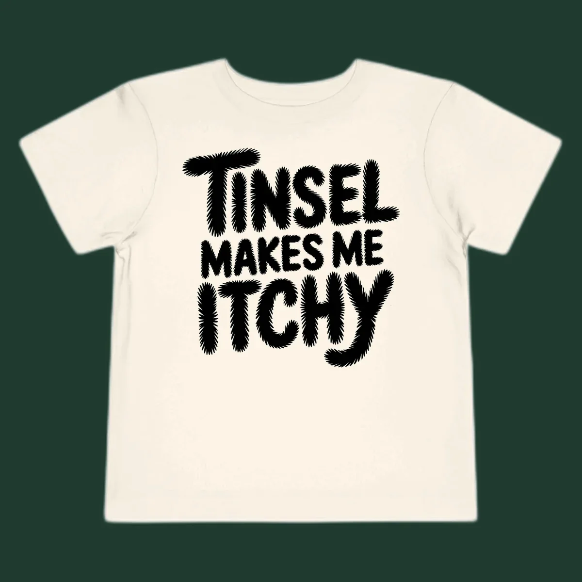 Text design reading "Tinsel Makes Me Itchy" in a fuzzy font.