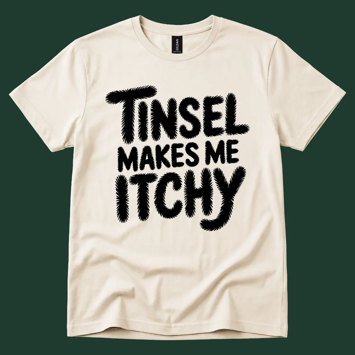 Text design reading "Tinsel Makes Me Itchy" in a fuzzy font.