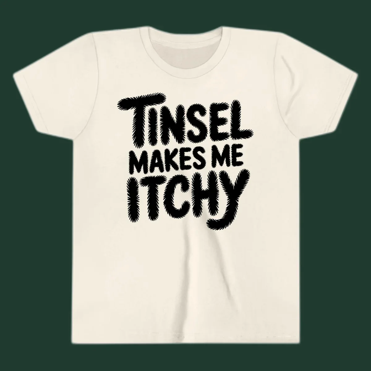 Text design reading "Tinsel Makes Me Itchy" in a fuzzy font.