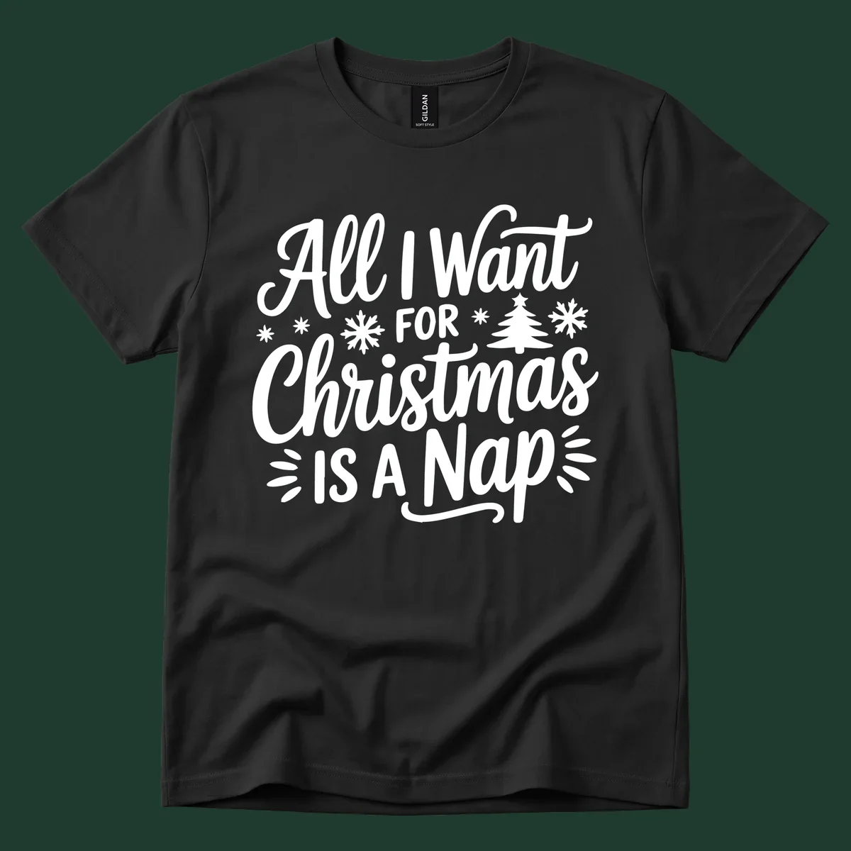 All I Want For Christmas Is A Nap typographic design with snowflakes and a Christmas tree.
