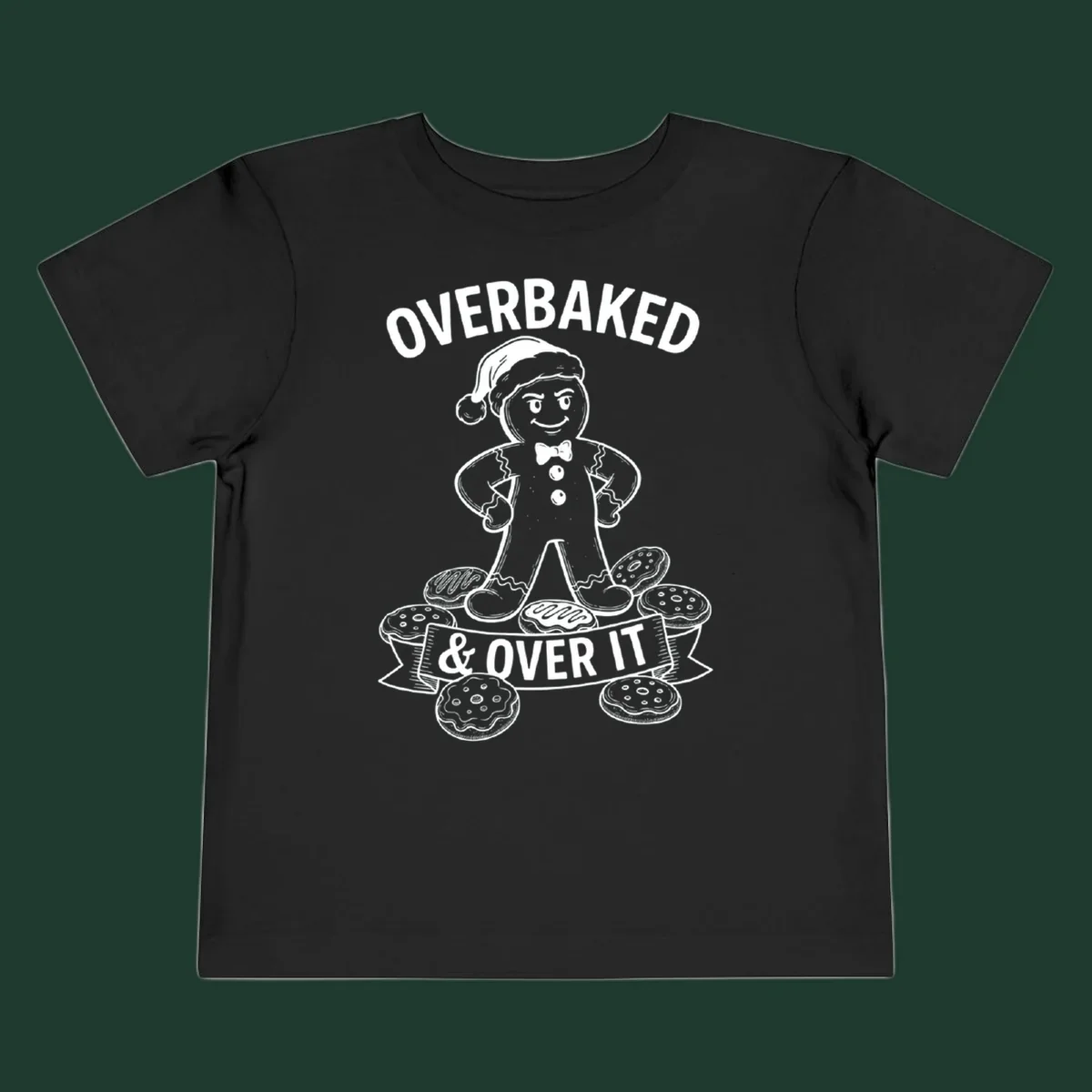 Overbaked gingerbread man with Santa hat and cookies, text says OVERBAKED & OVER IT.