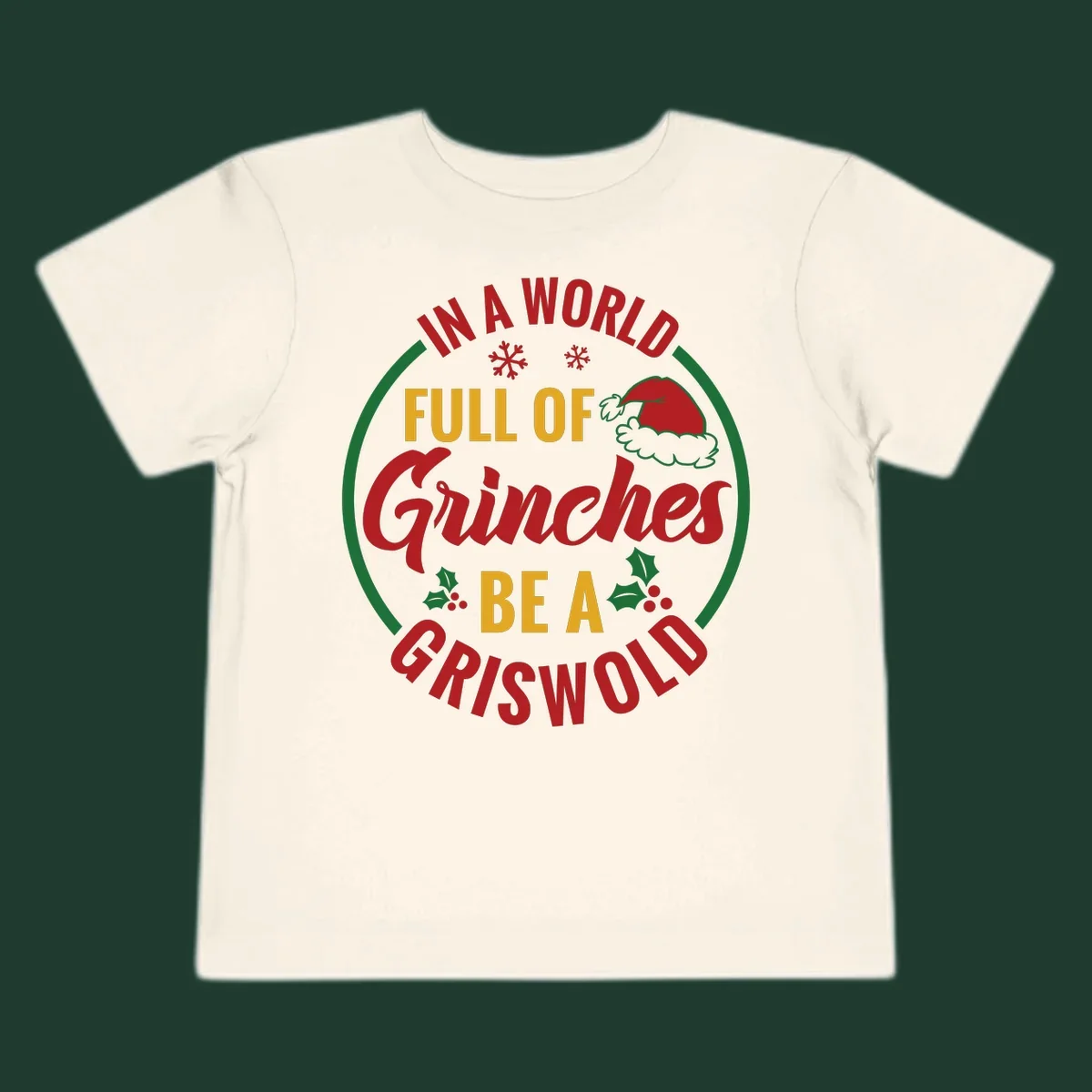 Circular design with text 'In A World Full Of Grinches Be A Griswold', snowflakes, Santa hat, and holly. Christmas graphic.