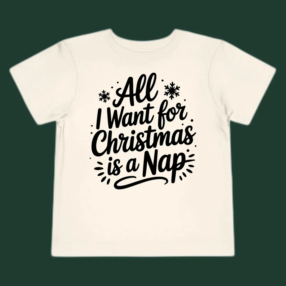 All I Want for Christmas Is A Nap typography design with snowflakes.