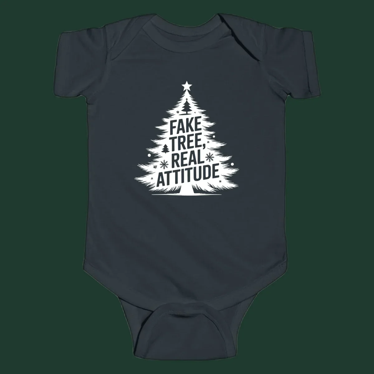 Christmas tree graphic with text 'FAKE TREE, REAL ATTITUDE' and snowflake accents.