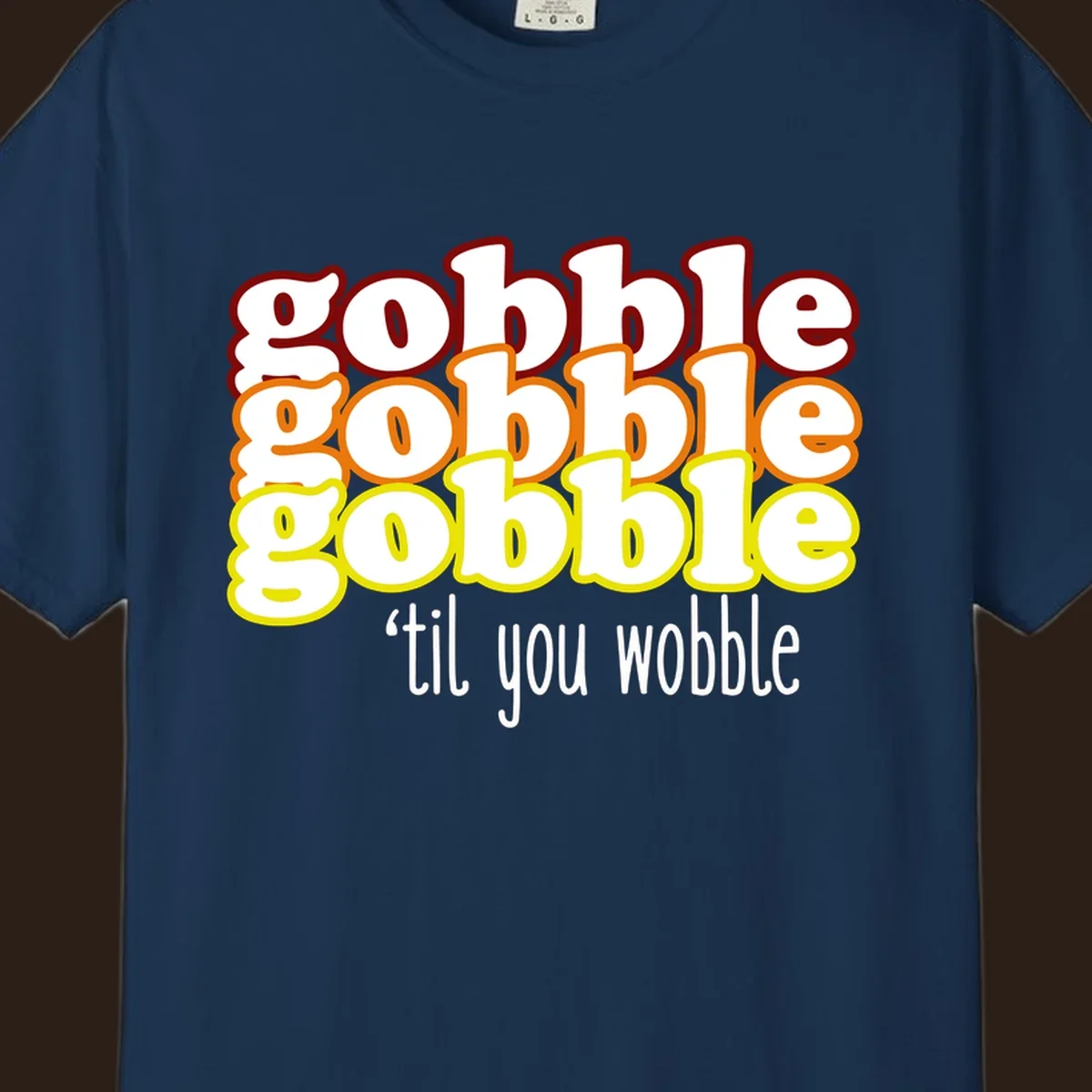 Gobble 'til you wobble thanksgiving text design with stacked gobble words in red, orange, yellow and white text below.
