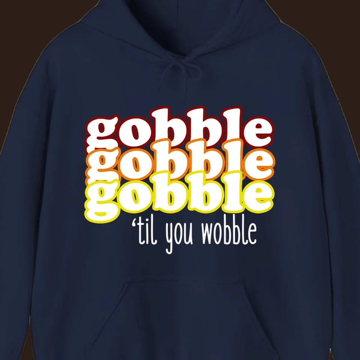 Gobble 'til you wobble thanksgiving text design with stacked gobble words in red, orange, yellow and white text below.