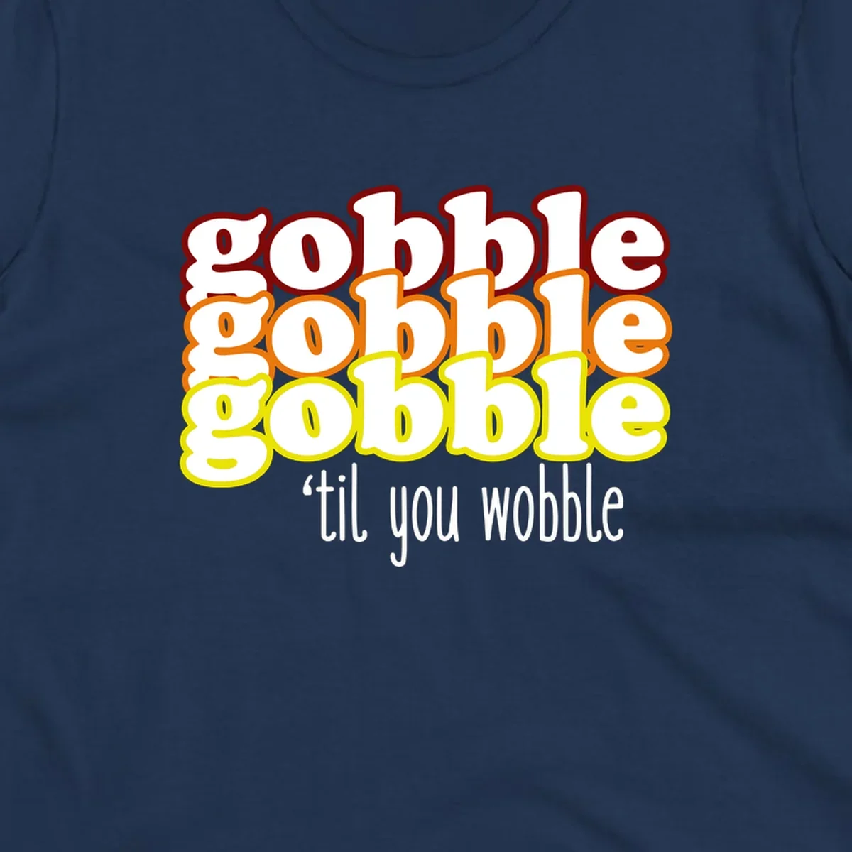 Gobble 'til you wobble thanksgiving text design with stacked gobble words in red, orange, yellow and white text below.