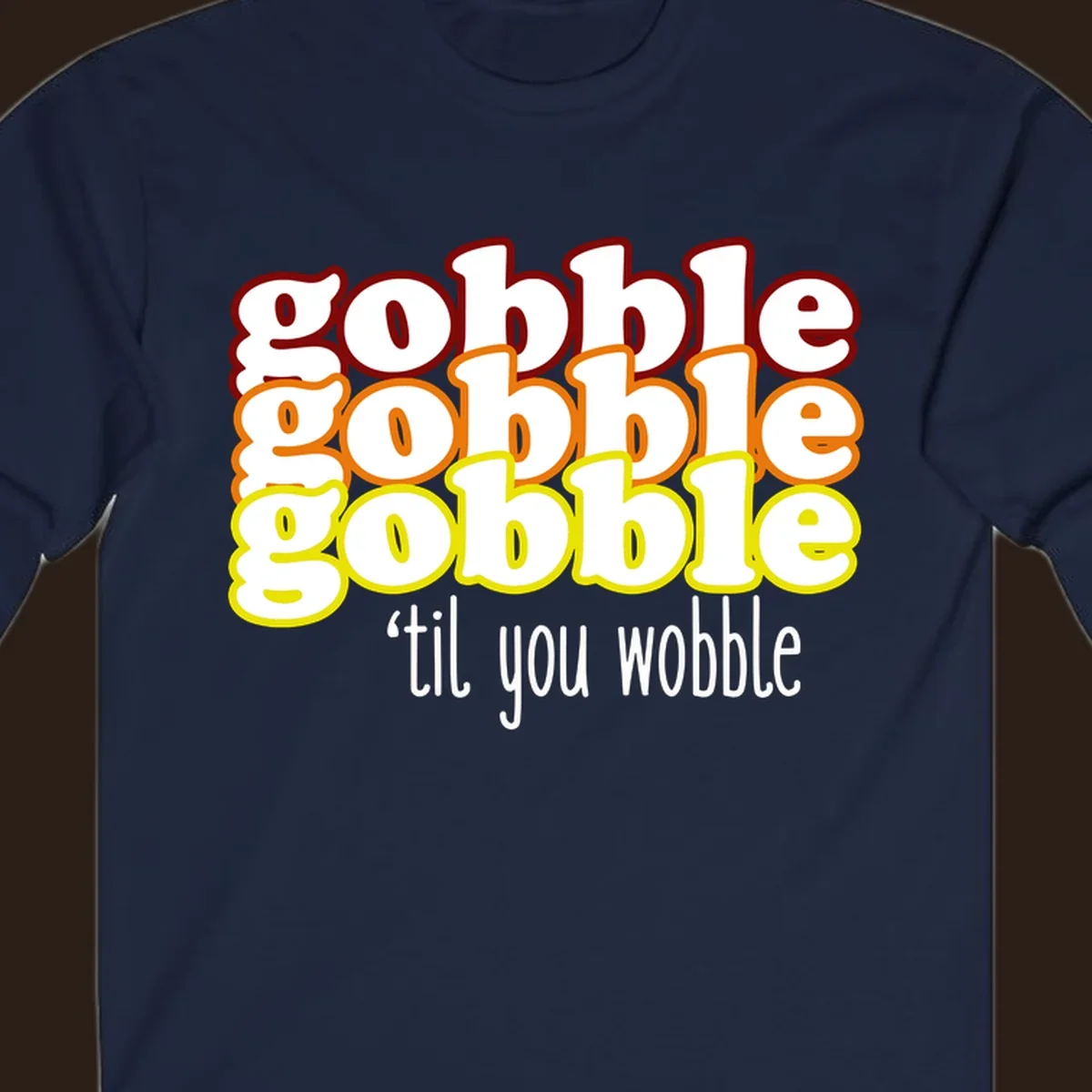 Gobble 'til you wobble thanksgiving text design with stacked gobble words in red, orange, yellow and white text below.