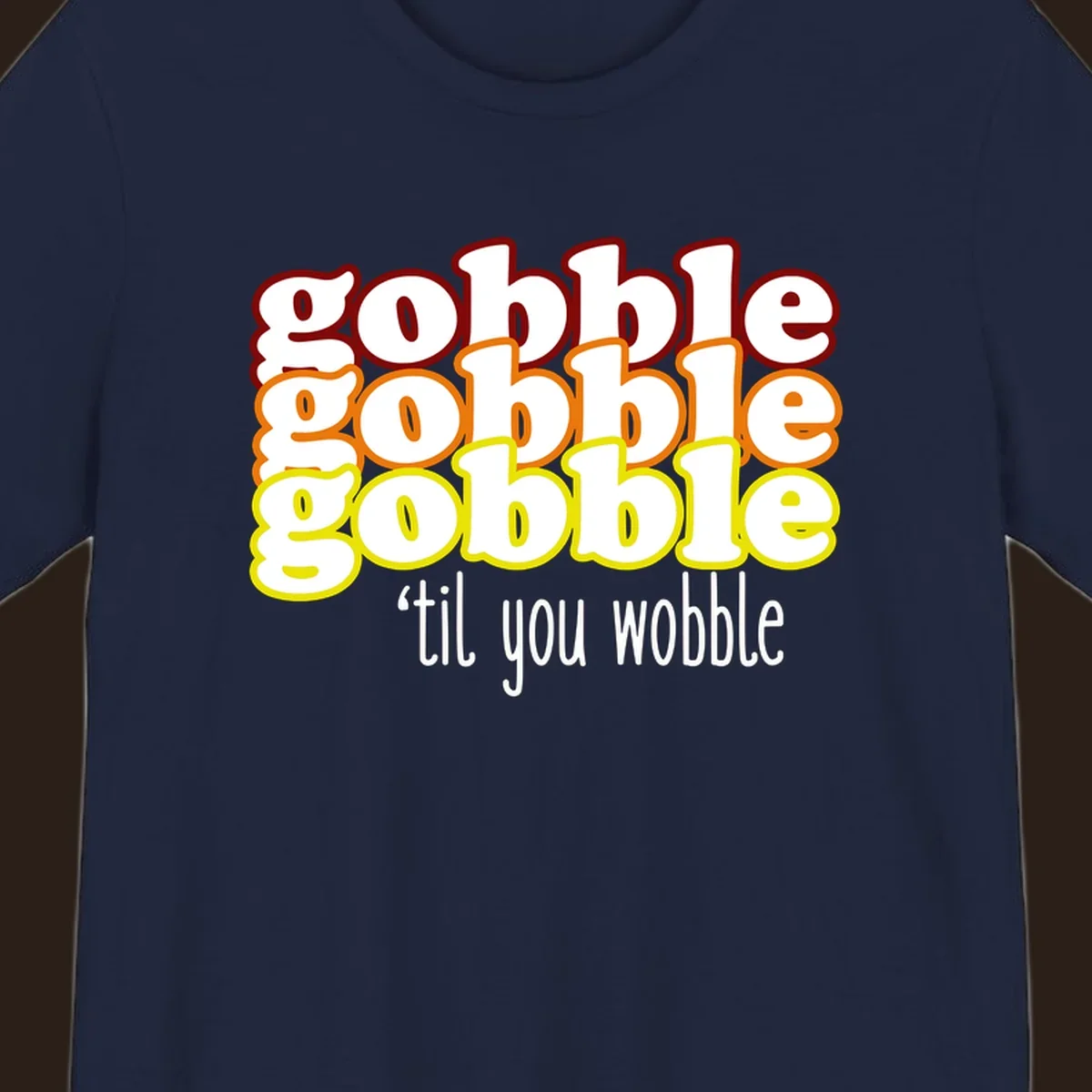 Gobble 'til you wobble thanksgiving text design with stacked gobble words in red, orange, yellow and white text below.
