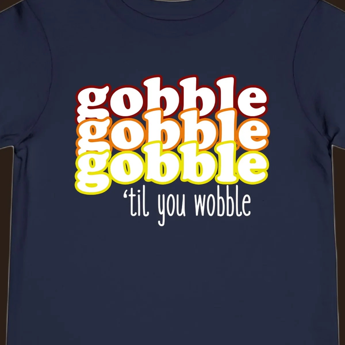 Gobble 'til you wobble thanksgiving text design with stacked gobble words in red, orange, yellow and white text below.