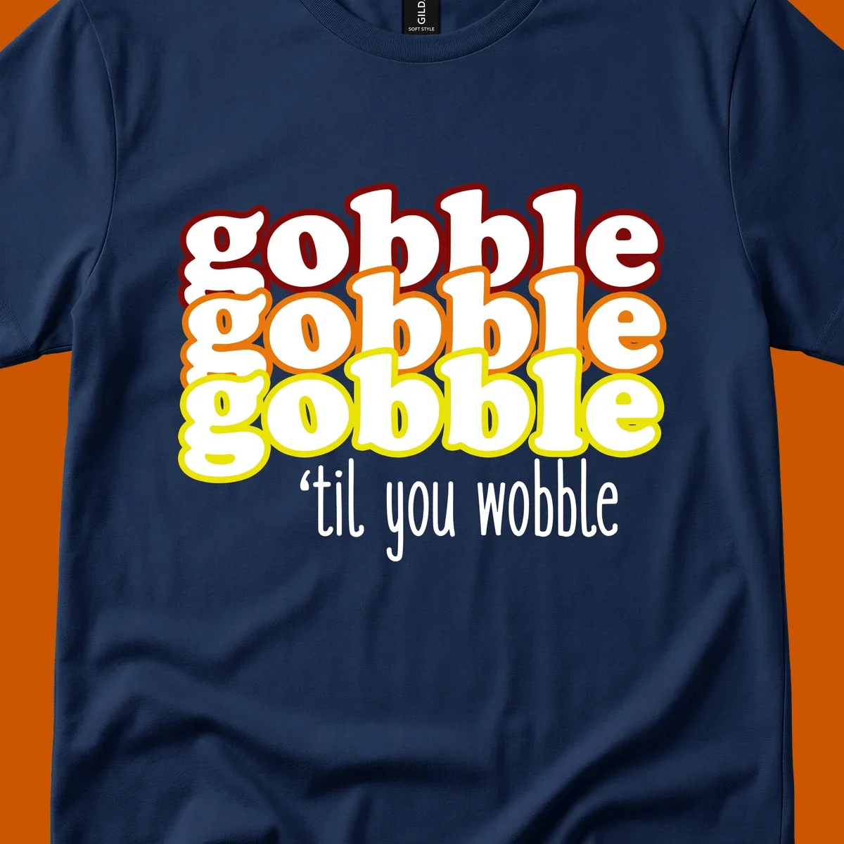 Gobble 'til you wobble thanksgiving text design with stacked gobble words in red, orange, yellow and white text below.