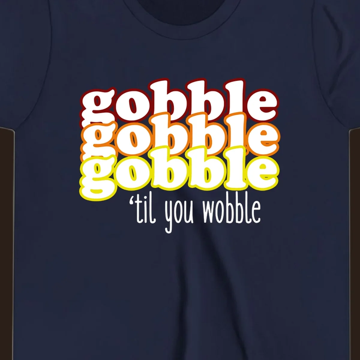 Gobble 'til you wobble thanksgiving text design with stacked gobble words in red, orange, yellow and white text below.