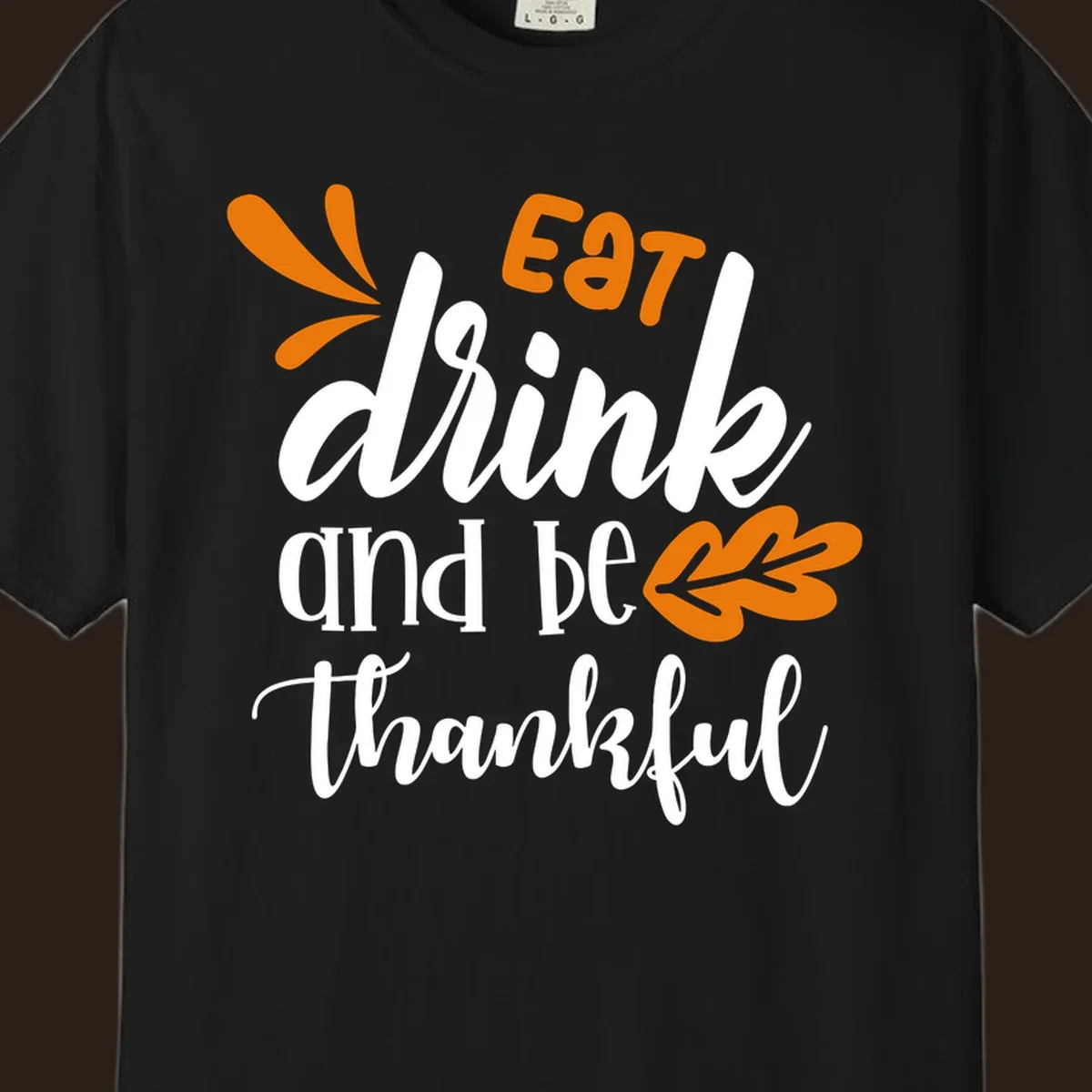 Eat Drink and Be Thankful Thanksgiving text and leaf graphic