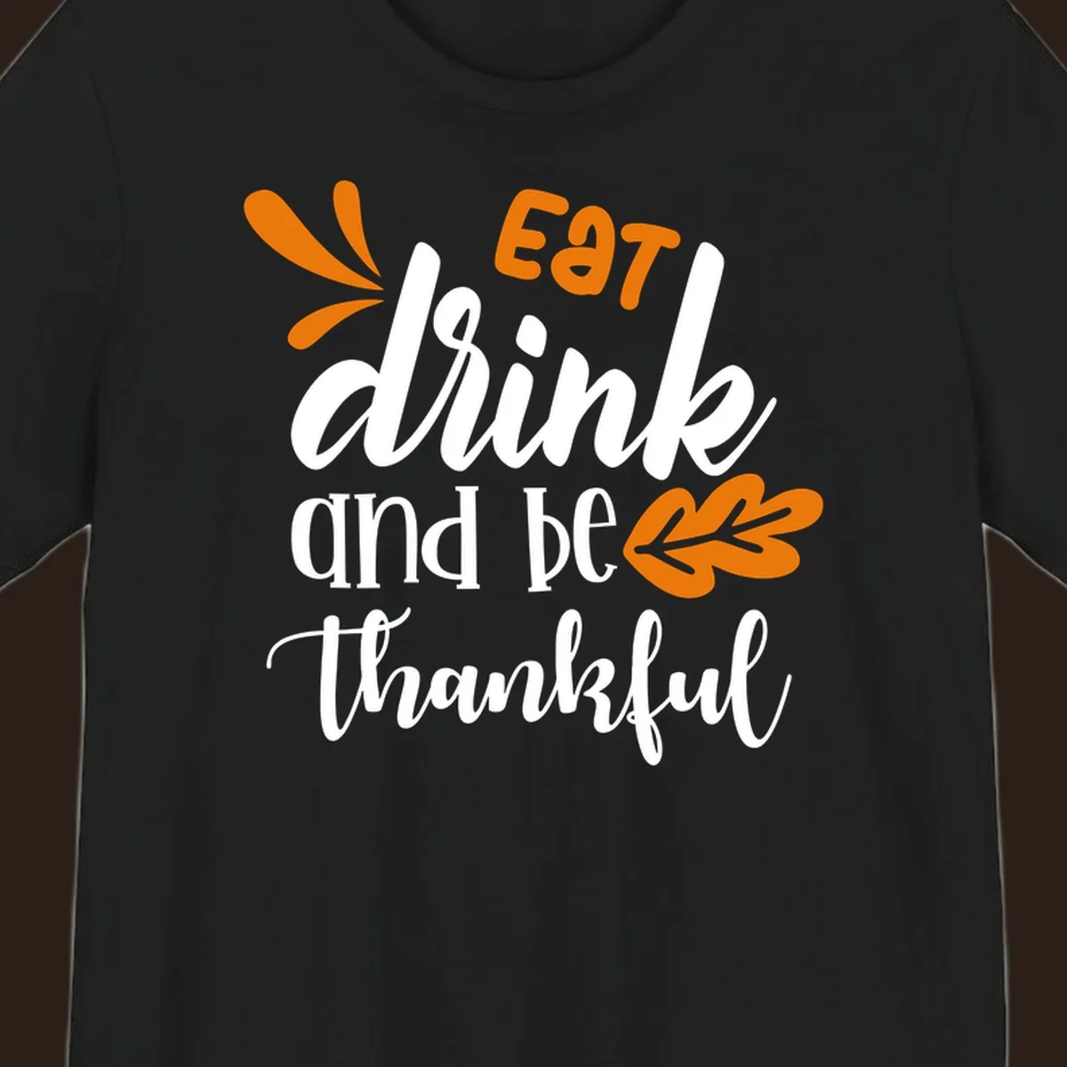 Eat Drink and Be Thankful Thanksgiving text and leaf graphic