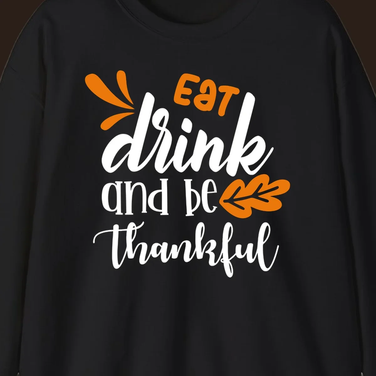 Eat Drink and Be Thankful Thanksgiving text and leaf graphic