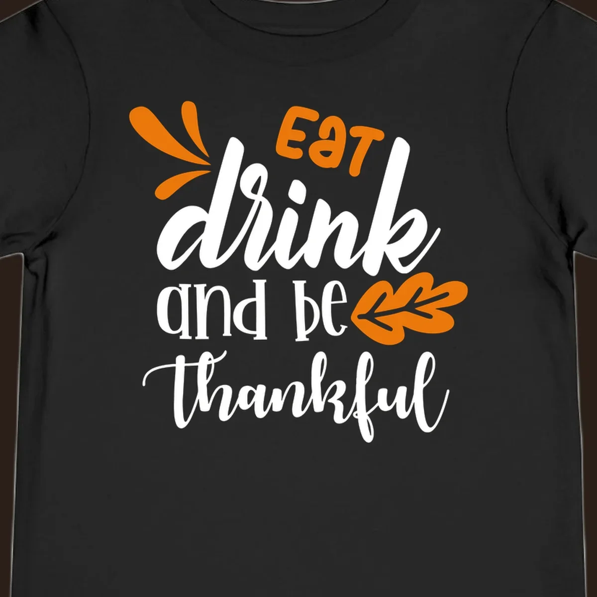 Eat Drink and Be Thankful Thanksgiving text and leaf graphic
