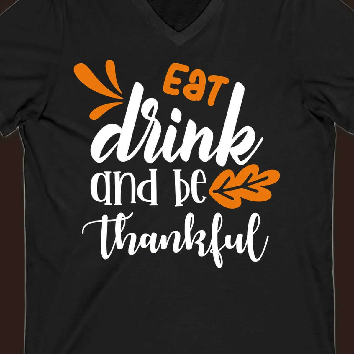 Eat Drink and Be Thankful Thanksgiving text and leaf graphic