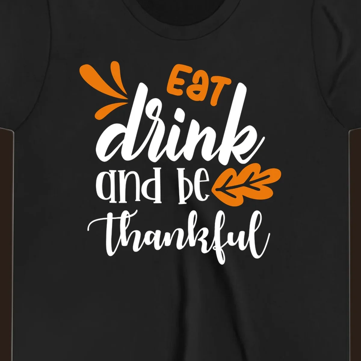 Eat Drink and Be Thankful Thanksgiving text and leaf graphic