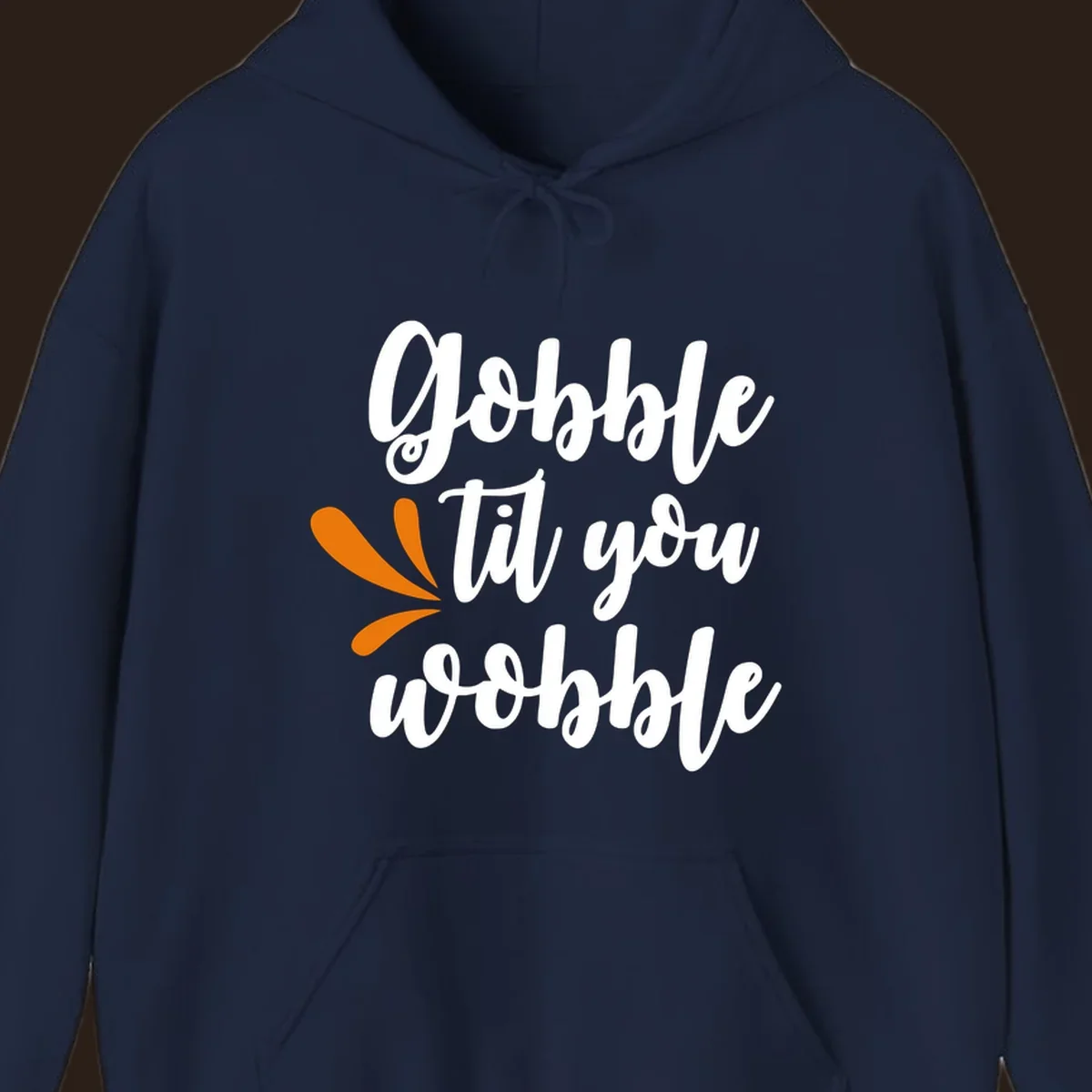 Gobble 'til you wobble Thanksgiving phrase with orange turkey feather illustrations.