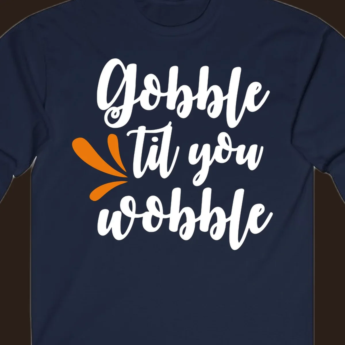 Gobble 'til you wobble Thanksgiving phrase with orange turkey feather illustrations.