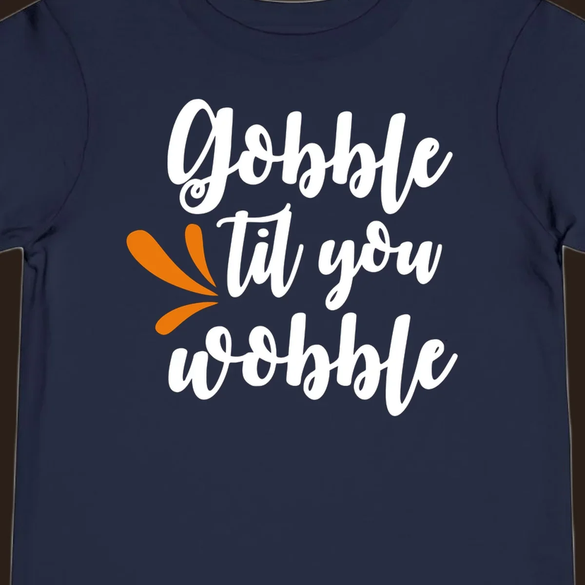Gobble 'til you wobble Thanksgiving phrase with orange turkey feather illustrations.
