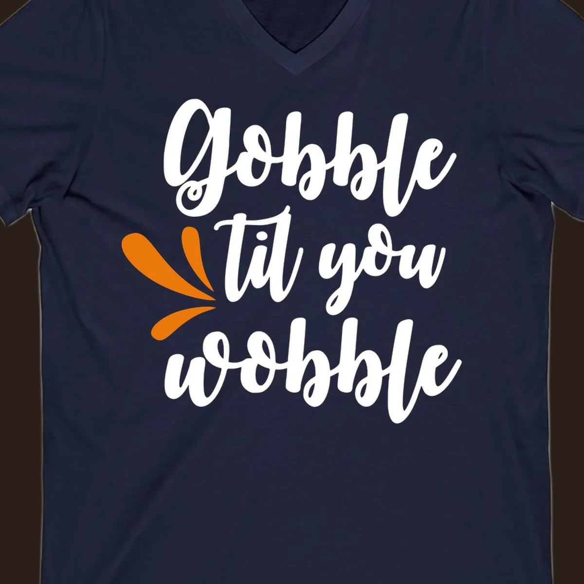 Gobble 'til you wobble Thanksgiving phrase with orange turkey feather illustrations.