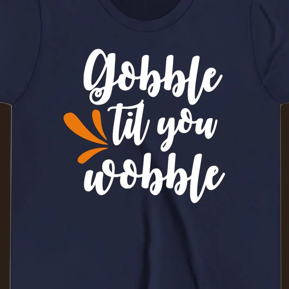 Gobble 'til you wobble Thanksgiving phrase with orange turkey feather illustrations.