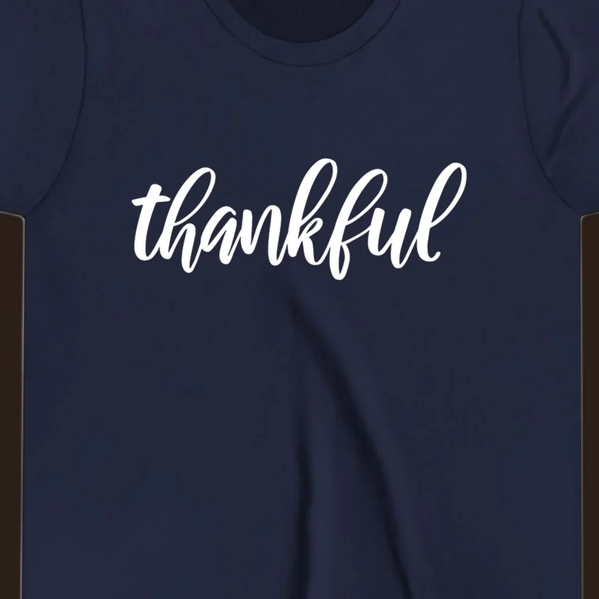 White script text spelling 'thankful' on a black background, representing thankful script word art.