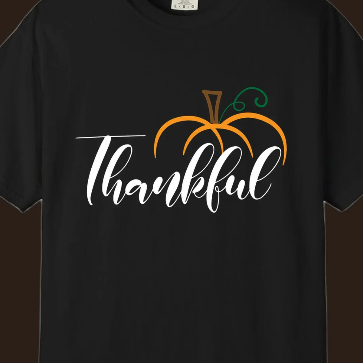 White script text 'Thankful' with a stylized orange pumpkin illustration.