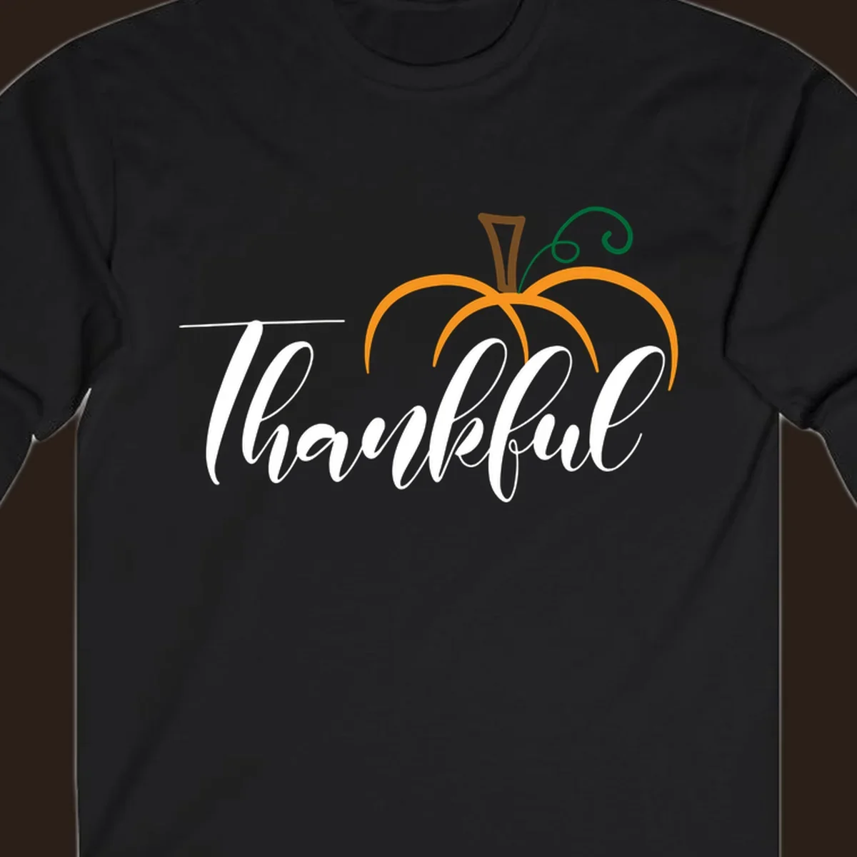 White script text 'Thankful' with a stylized orange pumpkin illustration.