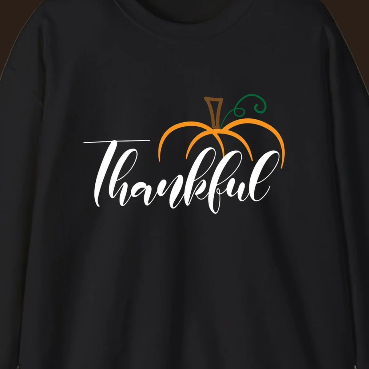 White script text 'Thankful' with a stylized orange pumpkin illustration.