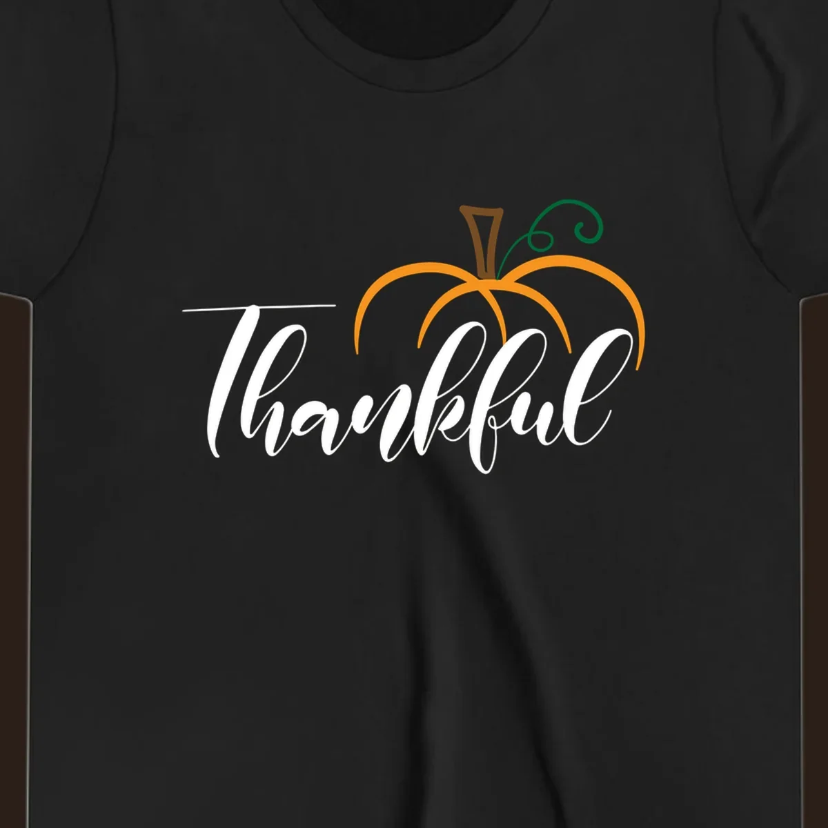 White script text 'Thankful' with a stylized orange pumpkin illustration.