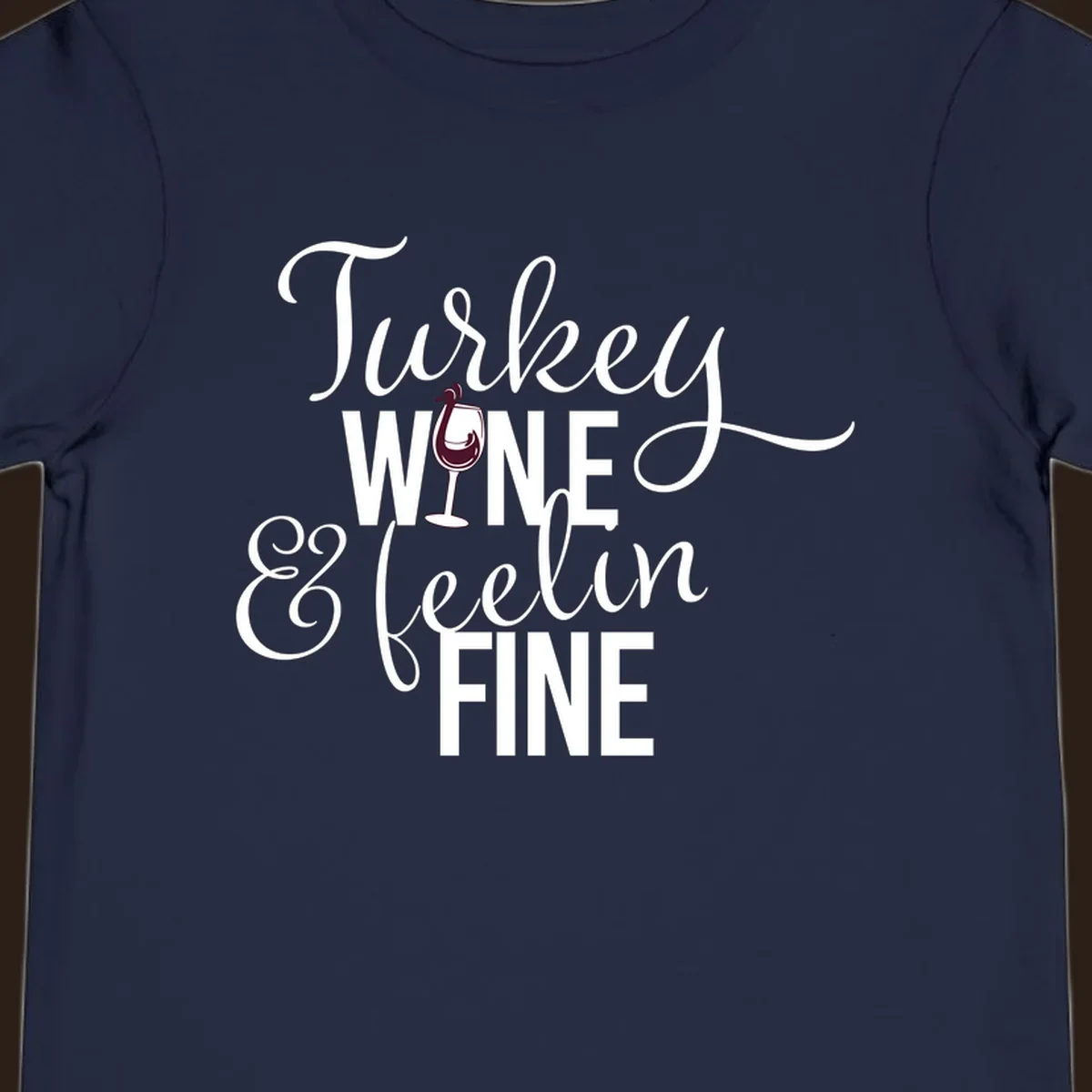 Turkey Wine Feelin Fine Thanksgiving design with text and wine glass illustration.