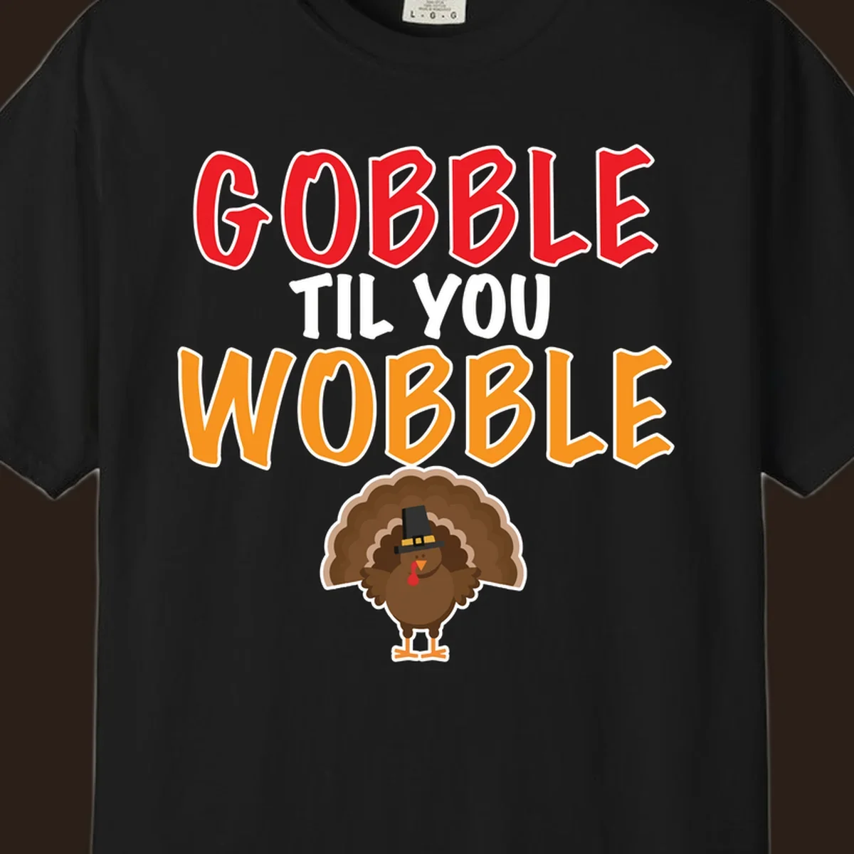 Gobble Til You Wobble text with a cartoon turkey wearing a pilgrim hat.