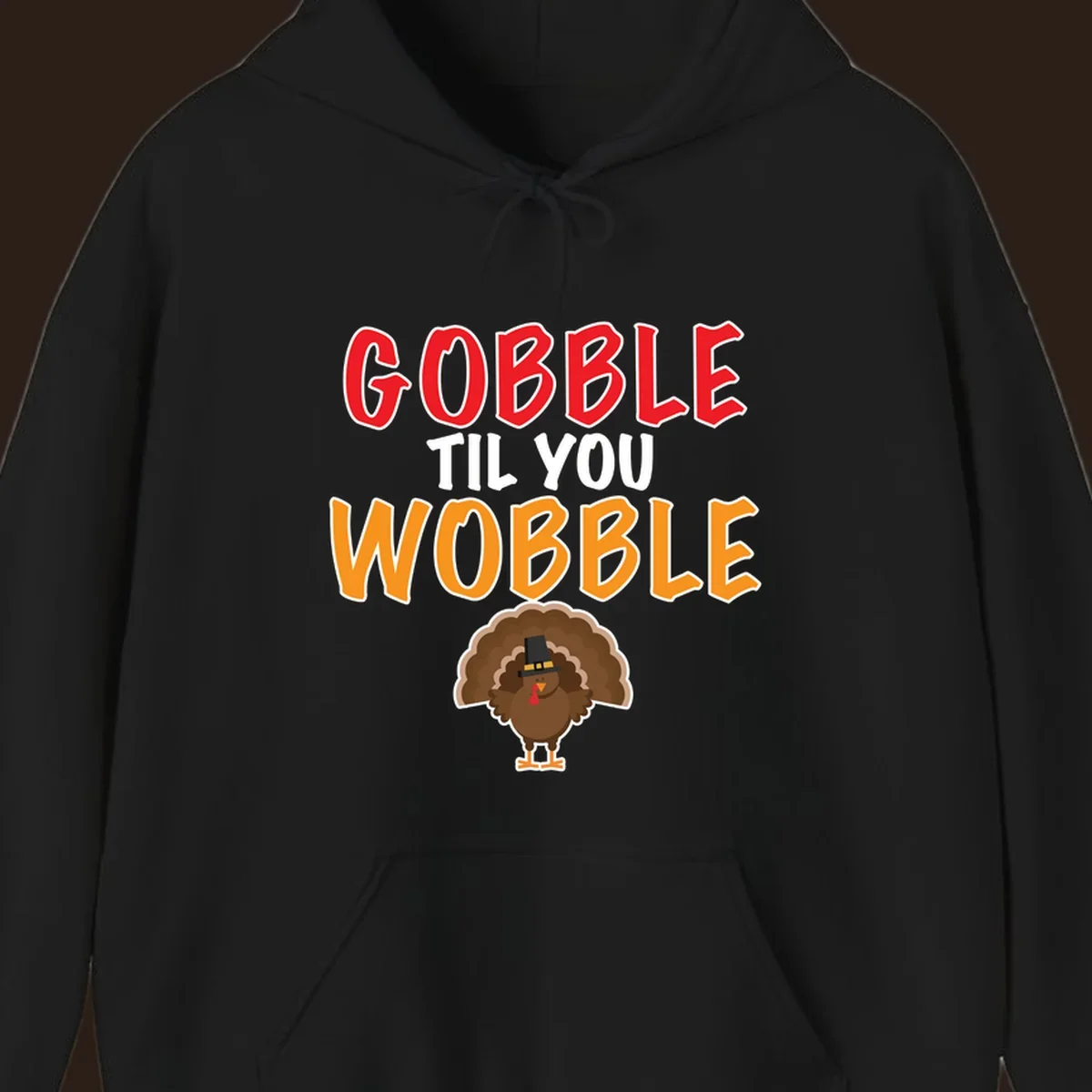 Gobble Til You Wobble text with a cartoon turkey wearing a pilgrim hat.