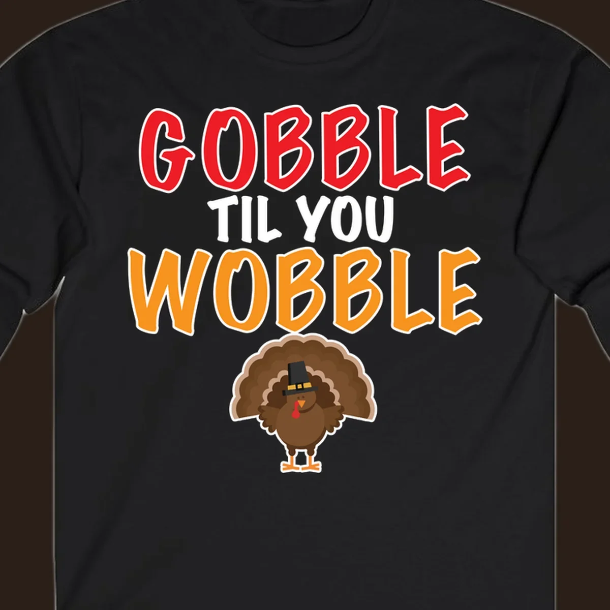 Gobble Til You Wobble text with a cartoon turkey wearing a pilgrim hat.