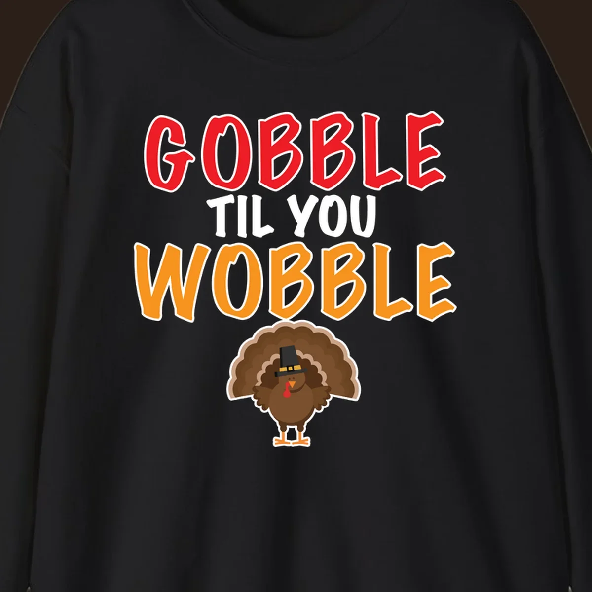 Gobble Til You Wobble text with a cartoon turkey wearing a pilgrim hat.