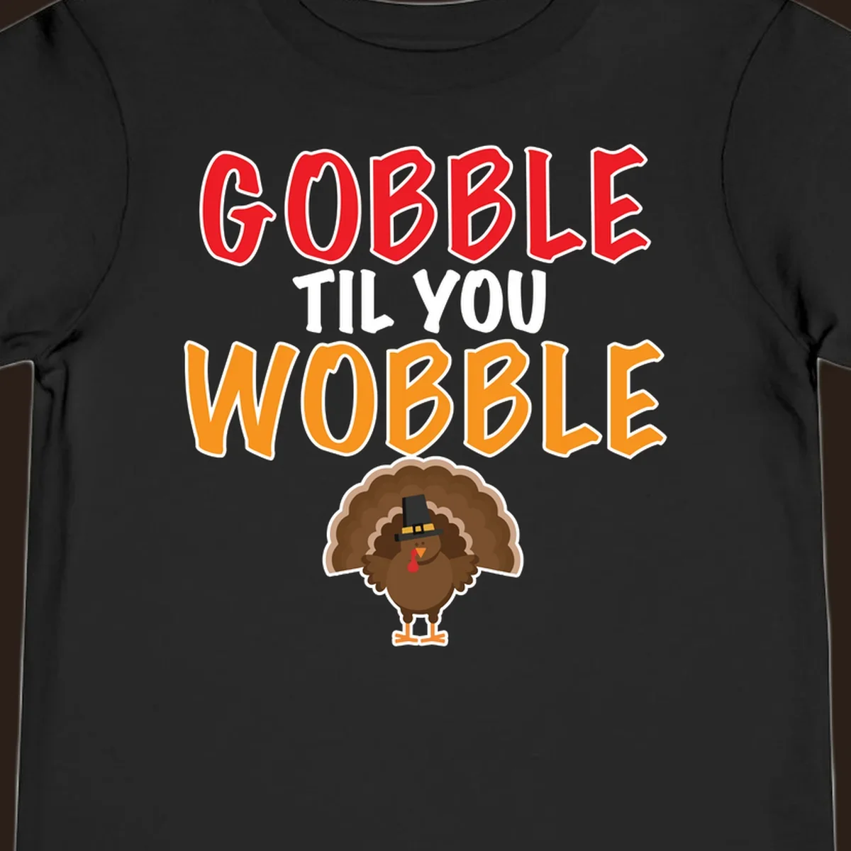 Gobble Til You Wobble text with a cartoon turkey wearing a pilgrim hat.