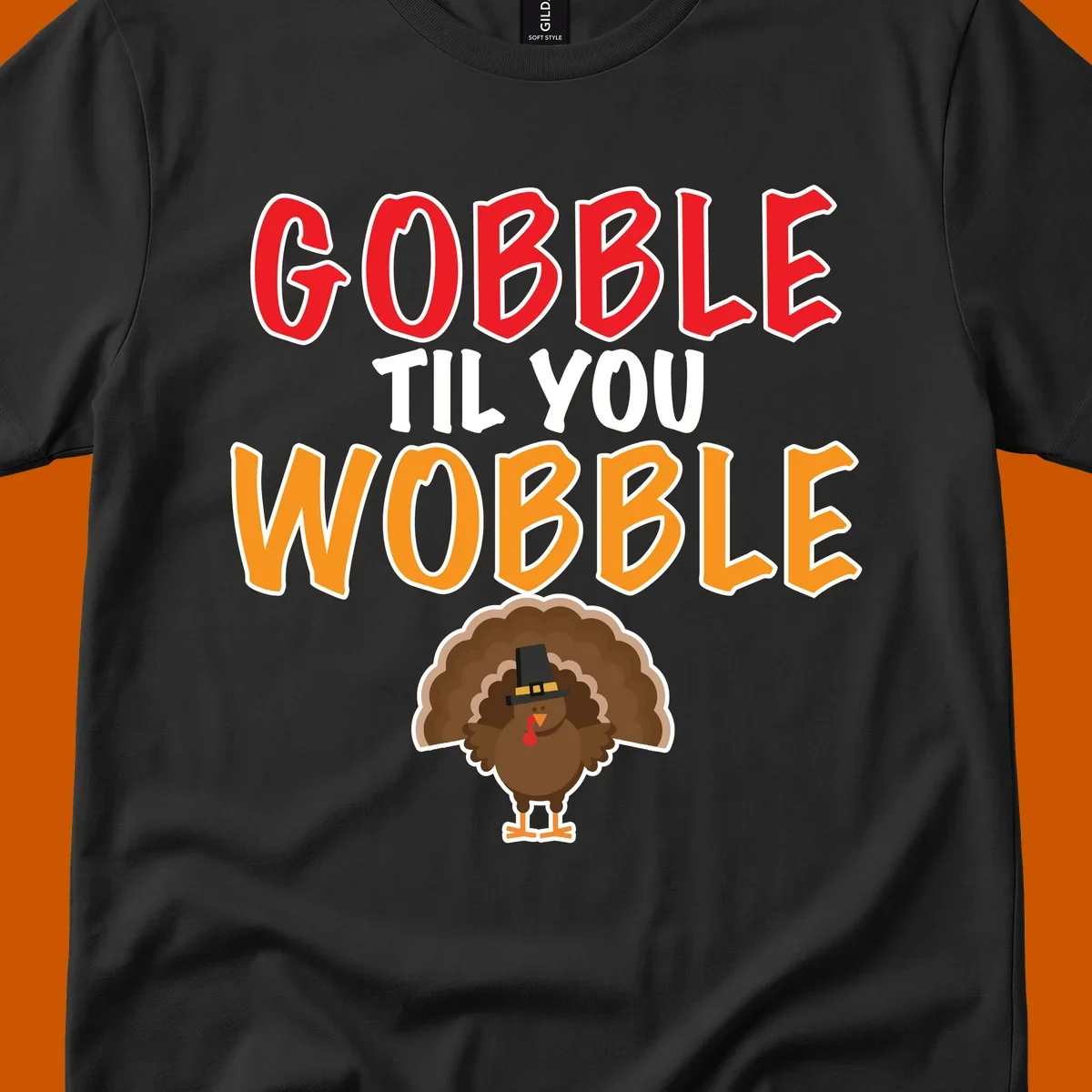Gobble Til You Wobble text with a cartoon turkey wearing a pilgrim hat.