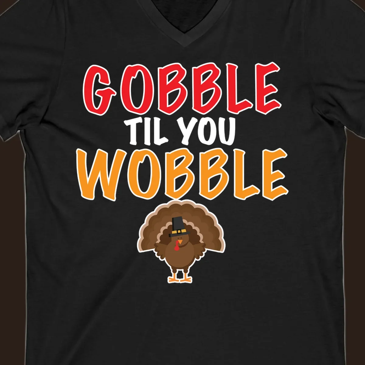 Gobble Til You Wobble text with a cartoon turkey wearing a pilgrim hat.