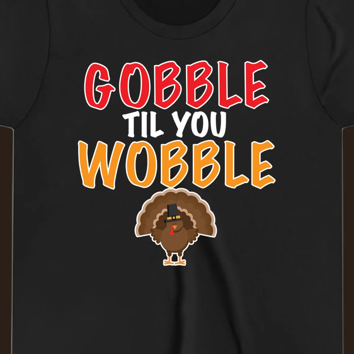 Gobble Til You Wobble text with a cartoon turkey wearing a pilgrim hat.