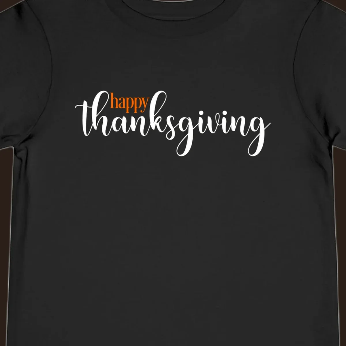 Happy Thanksgiving script design with orange 'happy' and white 'thanksgiving'.