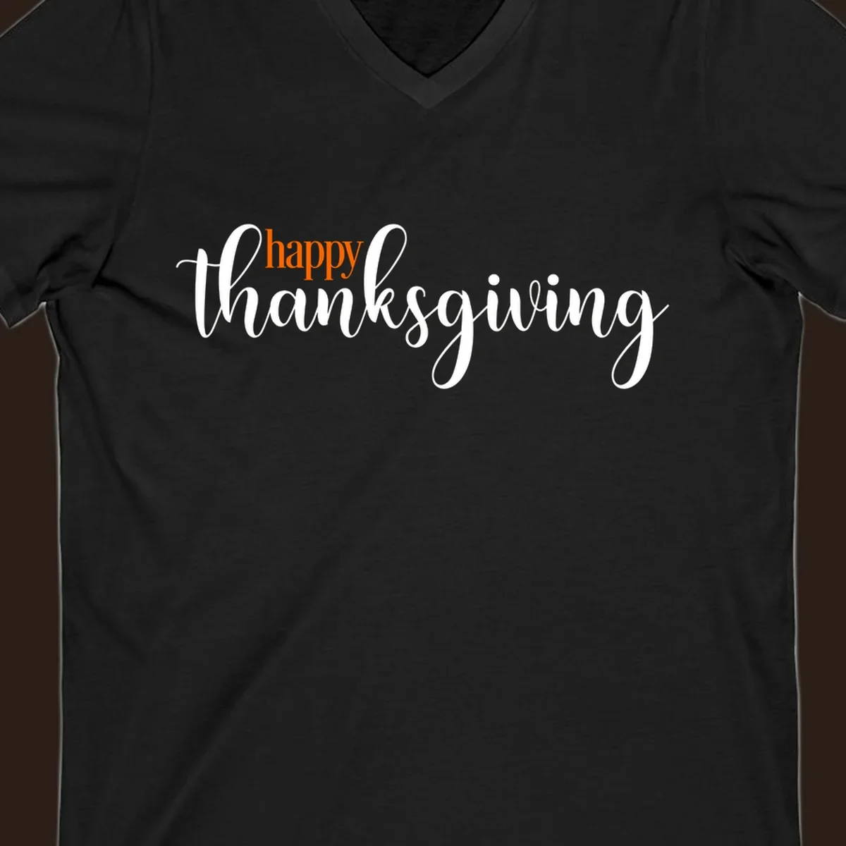 Happy Thanksgiving script design with orange 'happy' and white 'thanksgiving'.
