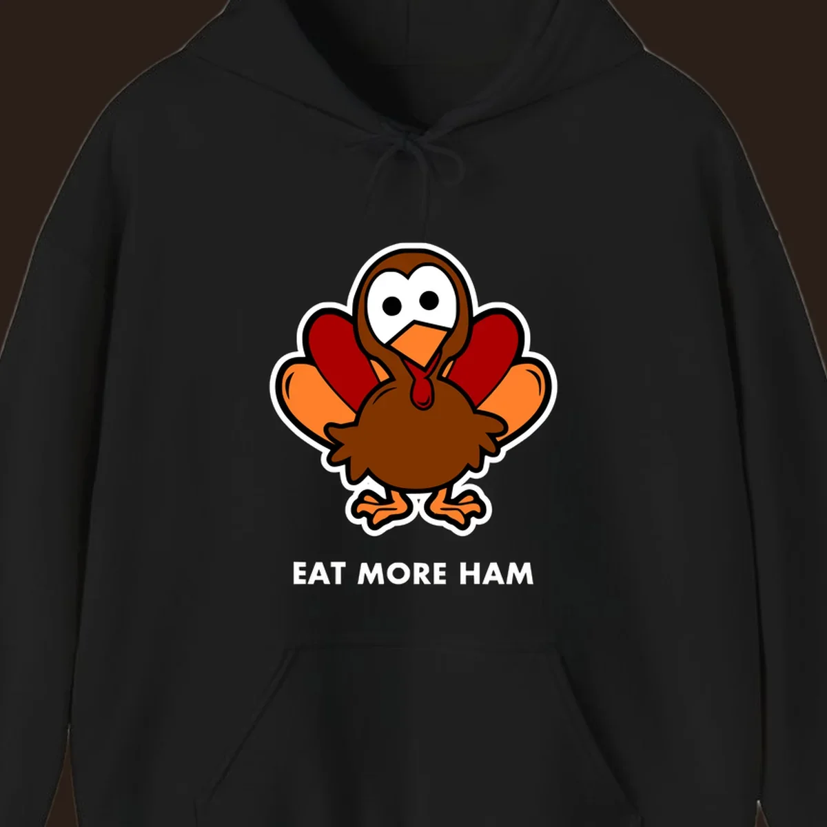 Cartoon turkey with 'Eat More Ham' text, promoting a fun Thanksgiving alternative.