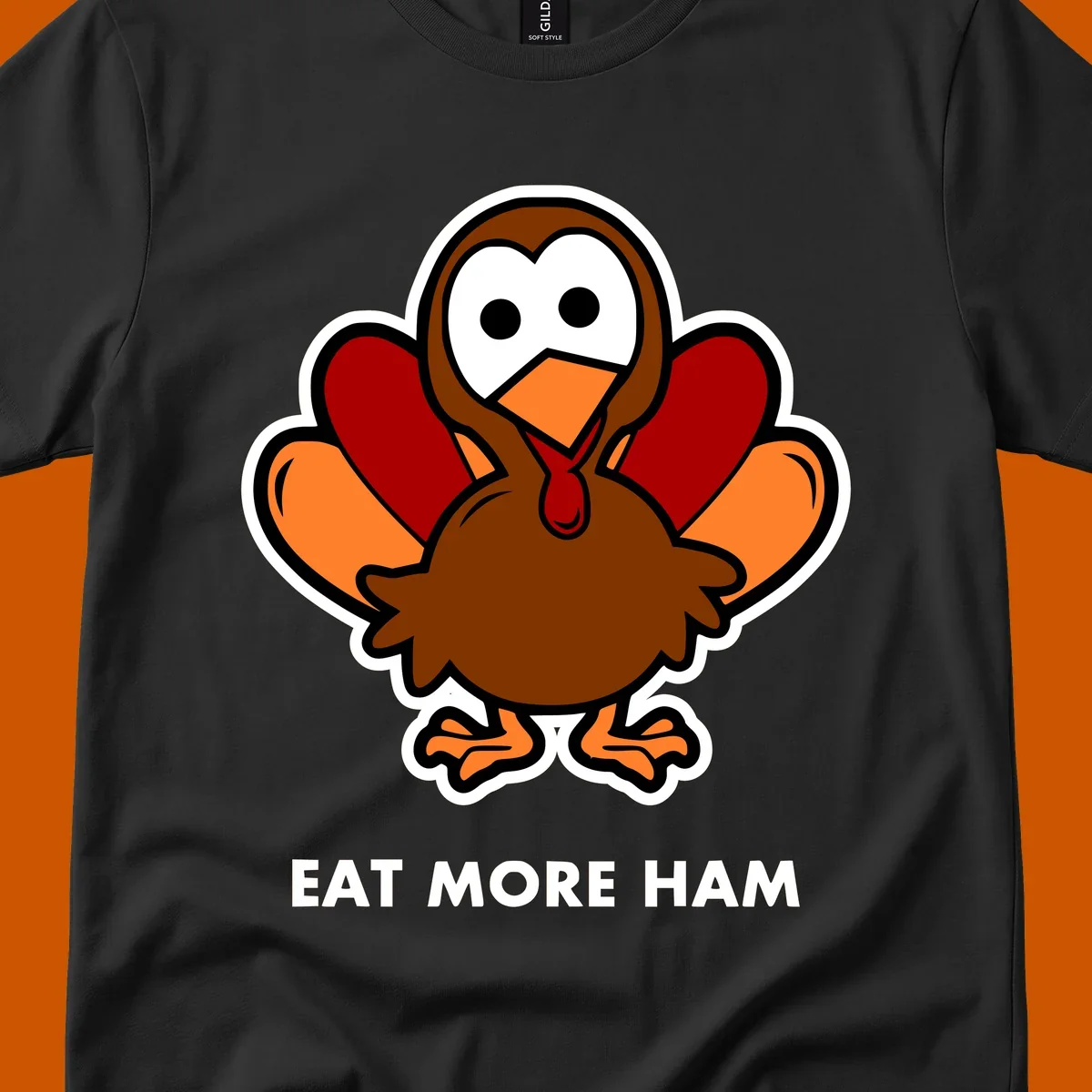 Cartoon turkey with 'Eat More Ham' text, promoting a fun Thanksgiving alternative.