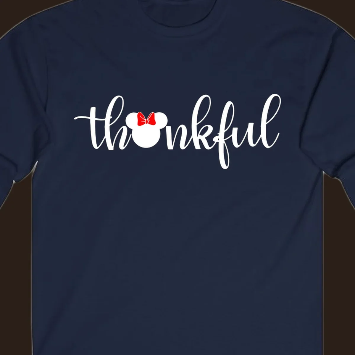 Minnie Mouse silhouette replaces the 'o' in the word 'thankful' in a script font.