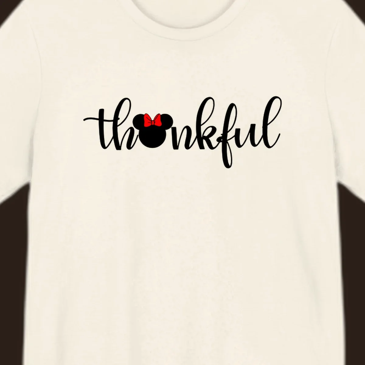 Minnie Mouse silhouette replaces the 'o' in the word 'thankful' in a script font.