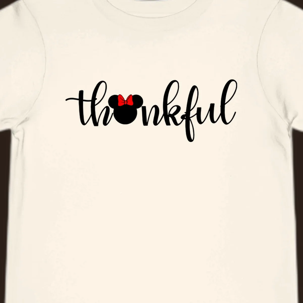 Minnie Mouse silhouette replaces the 'o' in the word 'thankful' in a script font.