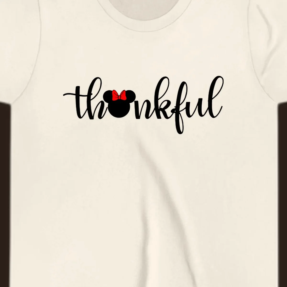 Minnie Mouse silhouette replaces the 'o' in the word 'thankful' in a script font.